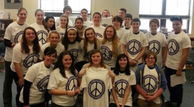 A group of people posing for a photo in a classroom.