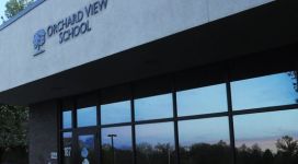 A building that says orchard view school at dusk.