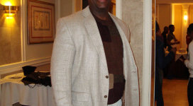 A man wearing a tan jacket.
