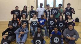 A group of people posing for a photo with peace signs.