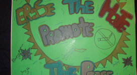A poster with the words'end the hole promote the peace'on it.
