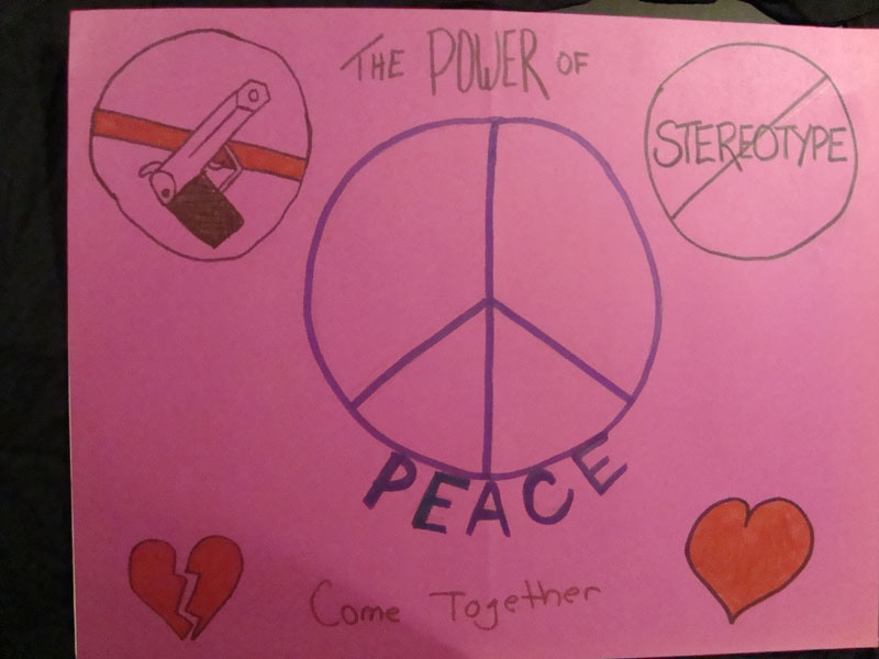 A pink poster with a peace sign, hearts, and a peace sign.