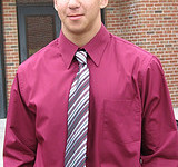 A man wearing a burgundy shirt.