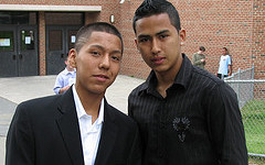 Two young men posing for a picture.