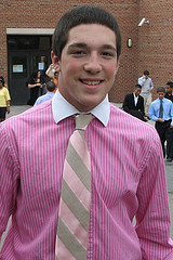 A man wearing a pink shirt and tie.
