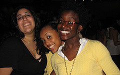 Three women posing for a picture at a party.