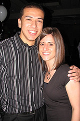 A man and a woman posing for a picture at a party.