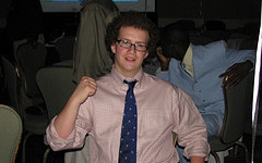 A man wearing a pink shirt and tie.