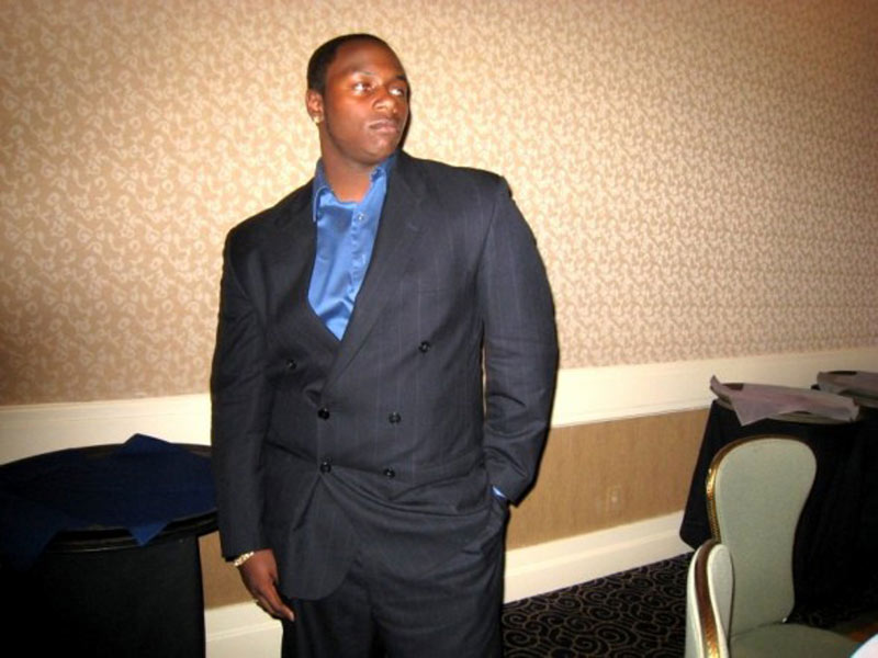 A man in a suit standing in a room.