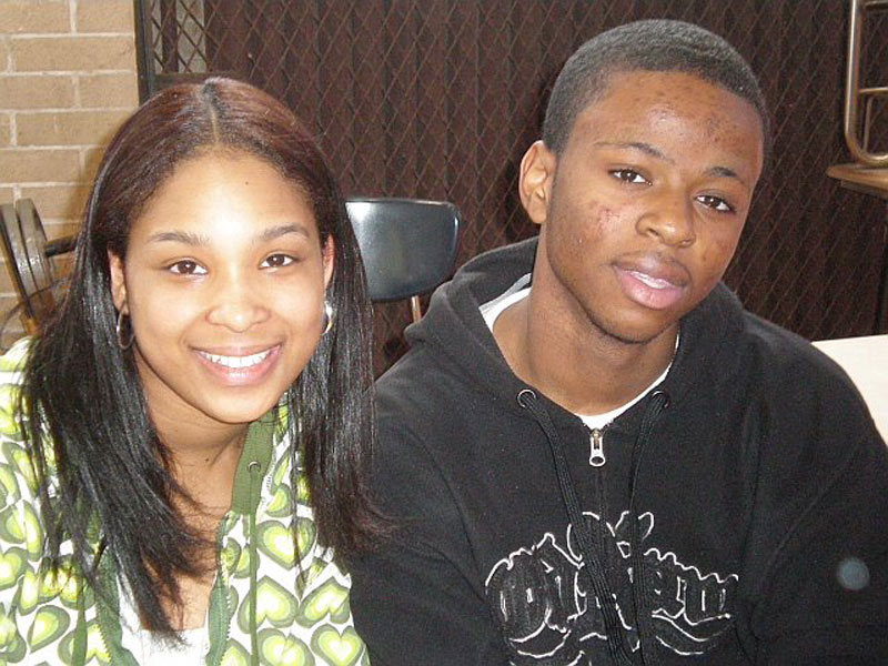 A young man and a young woman posing for a picture.