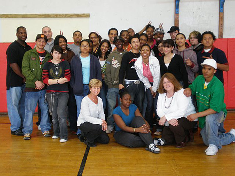 A group of people posing for a picture in a gym.