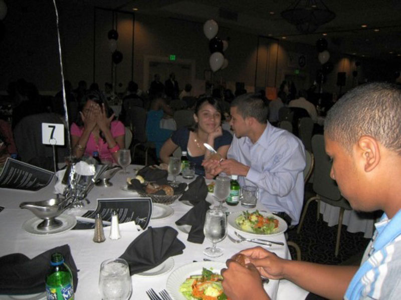 A group of people sitting at a table at a banquet.
