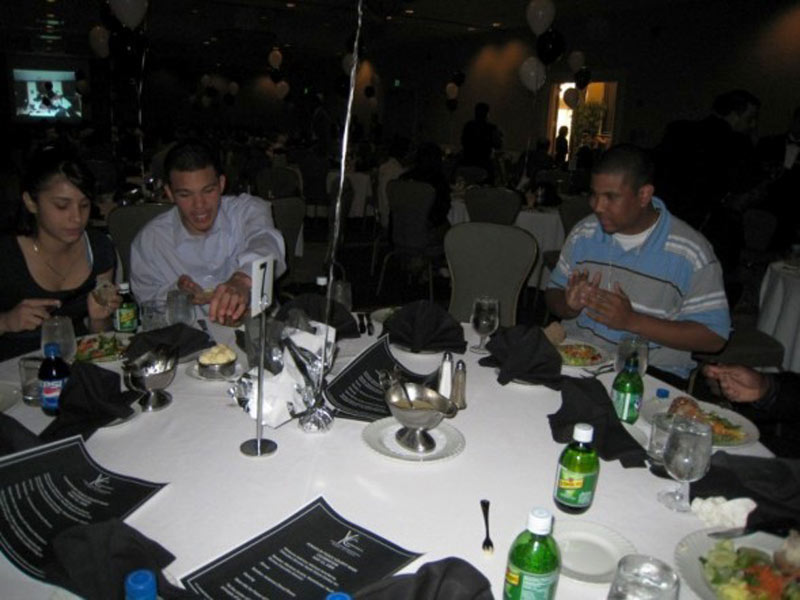 A group of people sitting around a table at a banquet.