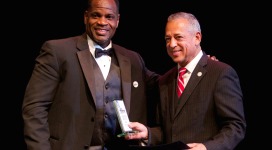 Two men in suits standing next to each other.