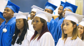 A group of graduates wearing graduation caps and gowns.